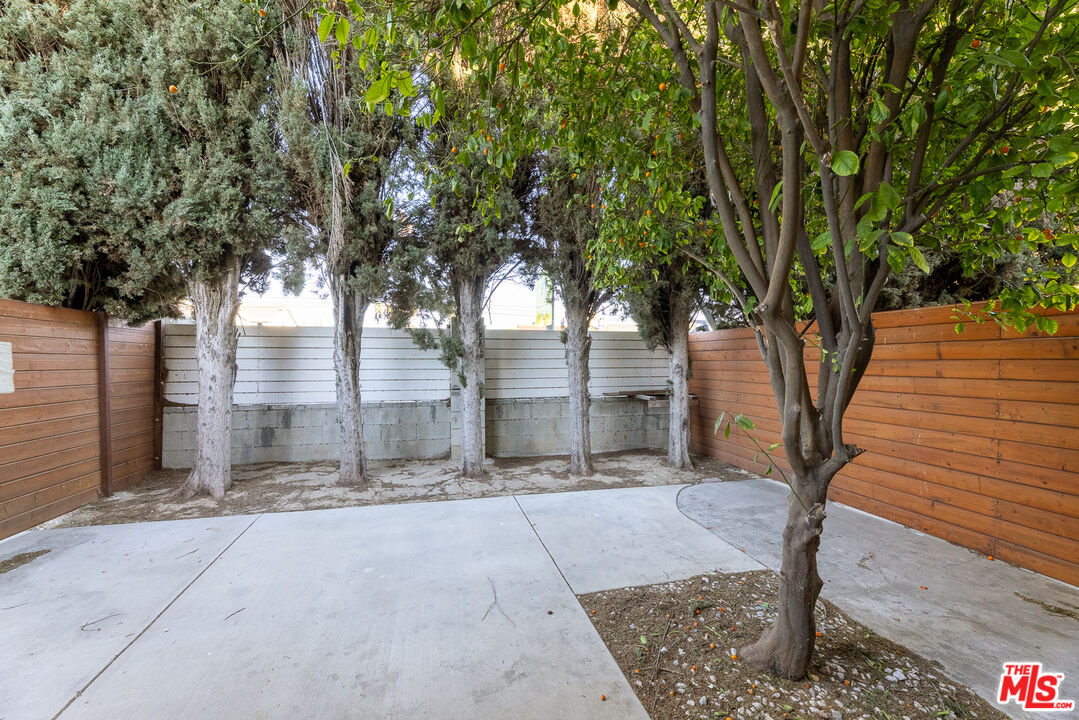 20102 Baltar Street Winnetka, CA 91306 - Photo 5 of 18 a pathway of a house with large trees