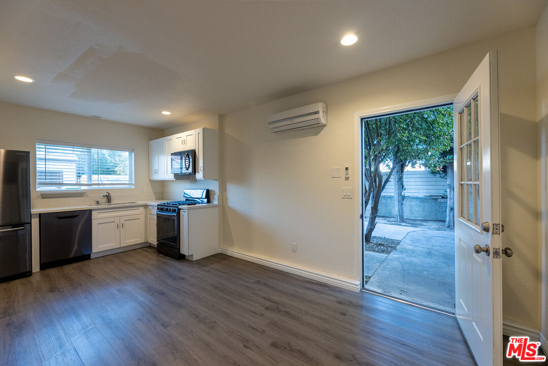 20102 Baltar Street Winnetka, CA 91306 - Photo 7 of 18 a view of a kitchen with a sink and a stove top oven