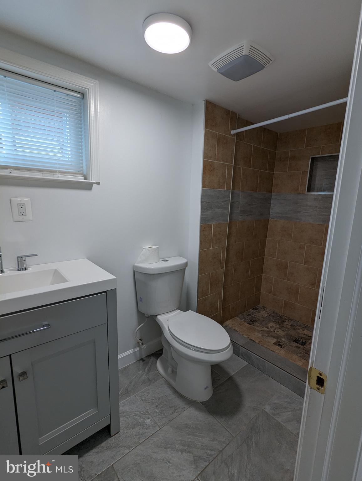2410 Darrow Street Silver Spring, MD 20902 - Photo 9 of 11 a bathroom with a sink toilet and shower