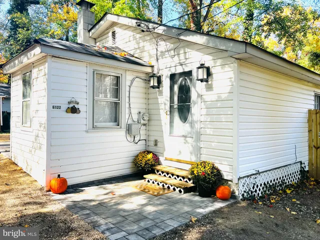 a view of a white house with many windows