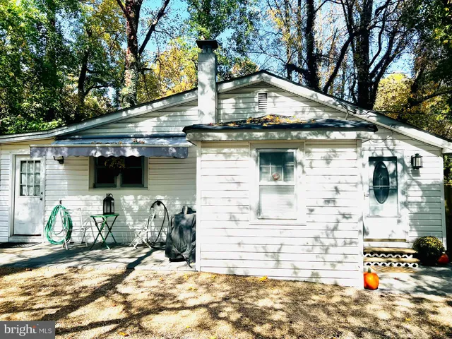 a view of a white house with large windows