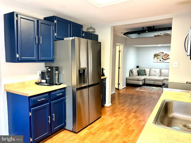 a kitchen with a refrigerator sink and cabinets