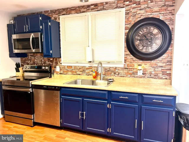 a kitchen with a sink and a stove