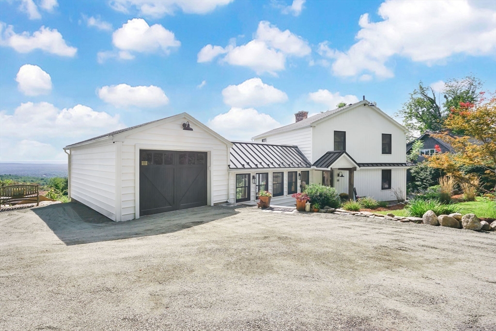 58 N Road Montgomery, MA 01085 - Photo 3 of 42 a front view of a house with a yard and garage