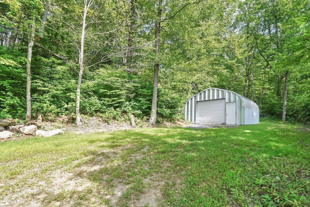 58 N Road Montgomery, MA 01085 - Photo 39 of 42 a house with a big yard and large trees