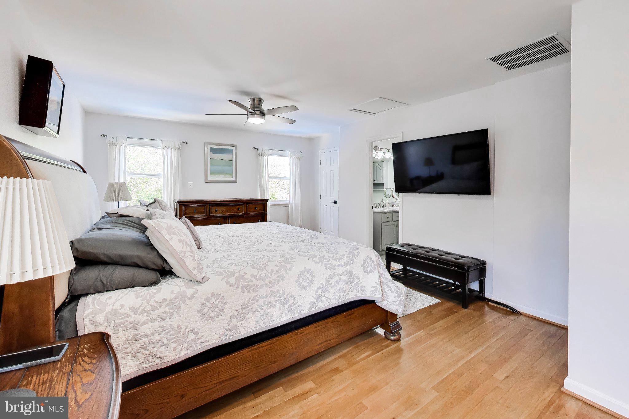14216 Alderton Road Silver Spring, MD 20906 - Photo 22 of 63 a bedroom with a bed and a flat screen tv