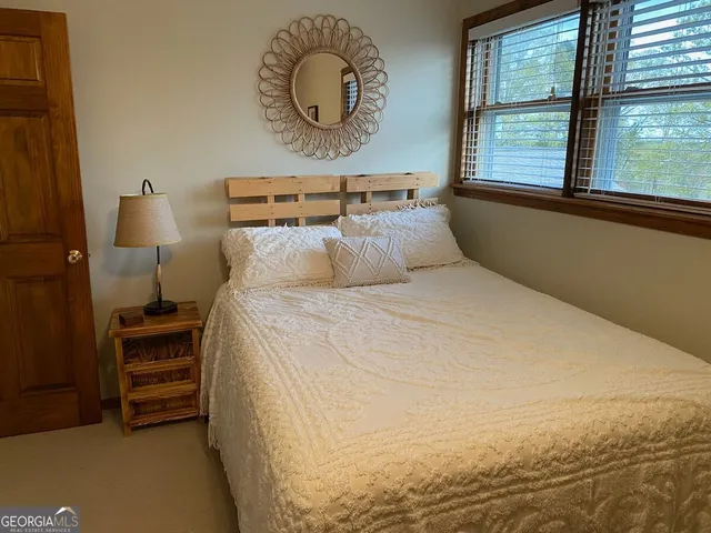 a bedroom with a bed and window