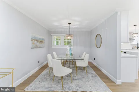 a dining room with furniture a window and a chandelier