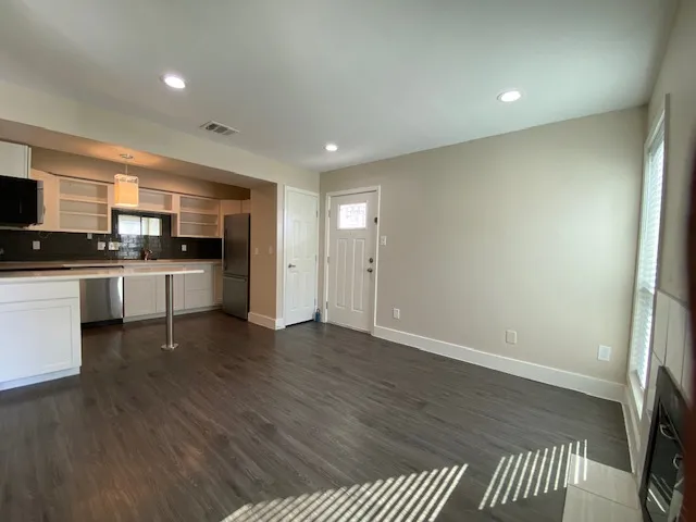 a large kitchen with stainless steel appliances granite countertop a stove a sink and a refrigerator