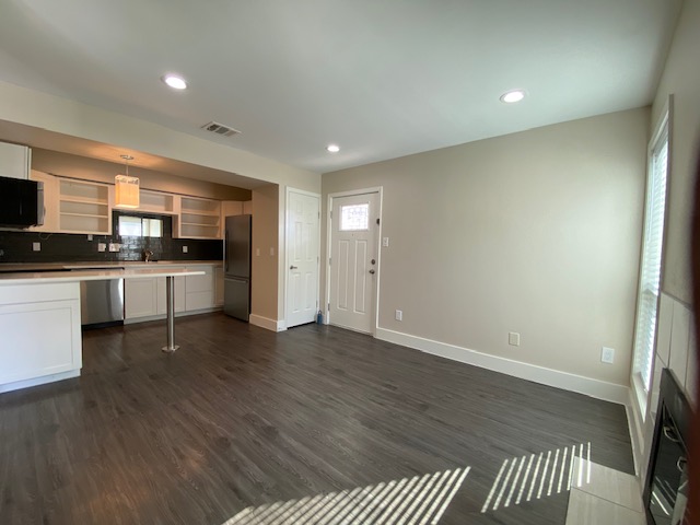 a large kitchen with stainless steel appliances granite countertop a stove a sink and a refrigerator