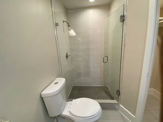 a white toilet sitting next to a bathroom sink