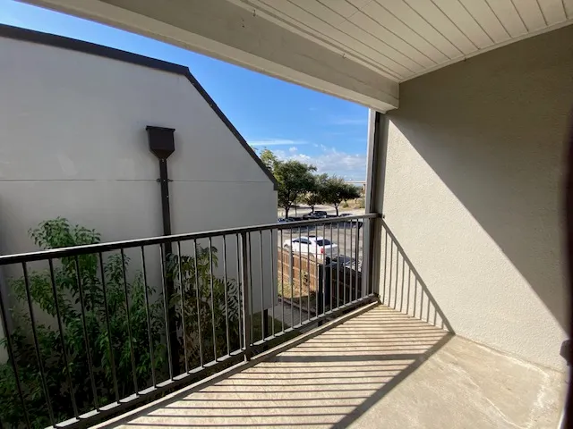 a view of balcony with wooden floor
