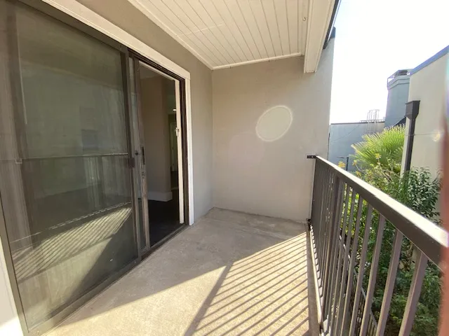 a view of balcony with wooden floor