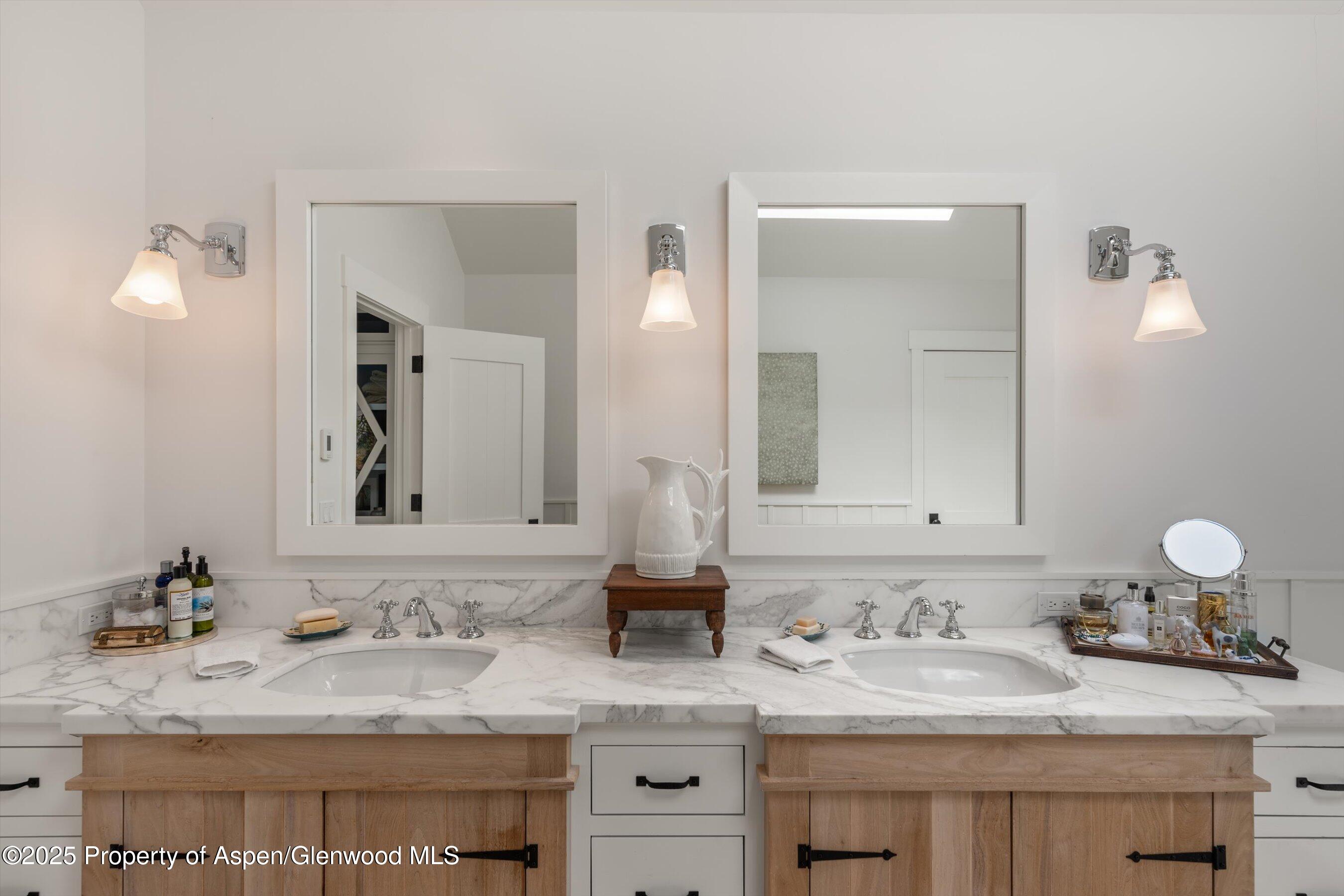 9555 Castle Creek Road Aspen, CO 81612 - Photo 16 of 42 a bathroom with a granite countertop sink and a mirror