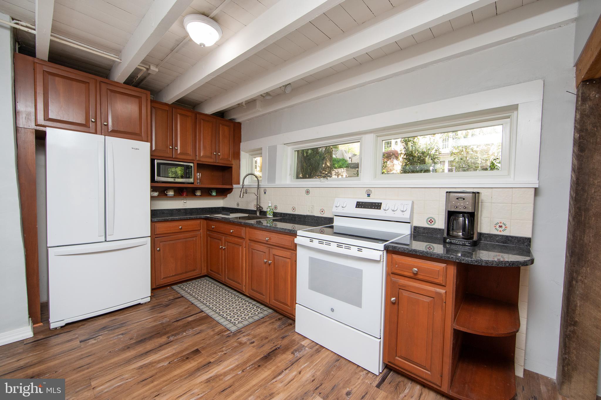2957 River Road New Hope, PA 18938 - Photo 7 of 30 a kitchen with stainless steel appliances granite countertop a stove a sink dishwasher a refrigerator and a microwave oven with cabinets