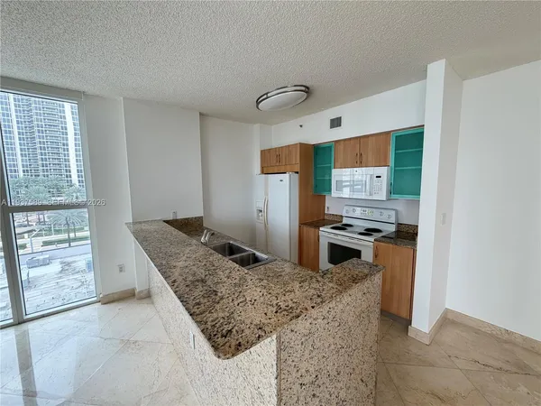 a kitchen that has a sink and a stove