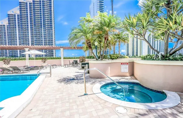 a swimming pool view with a outdoor seating