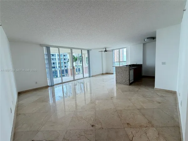 a view of a livingroom with furniture and an entryway