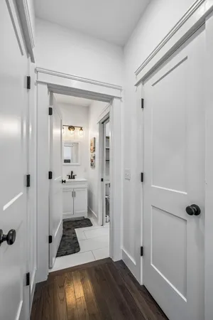 a bathroom with a sink and glass door with shower