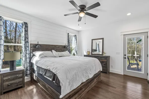 a bedroom with a bed and a large window