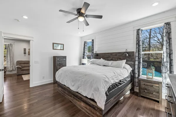 a bedroom with a large bed and a chandelier