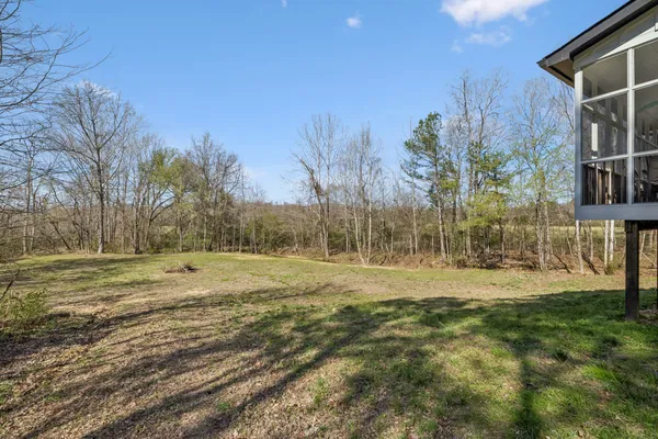 a view of a field with a house in the background