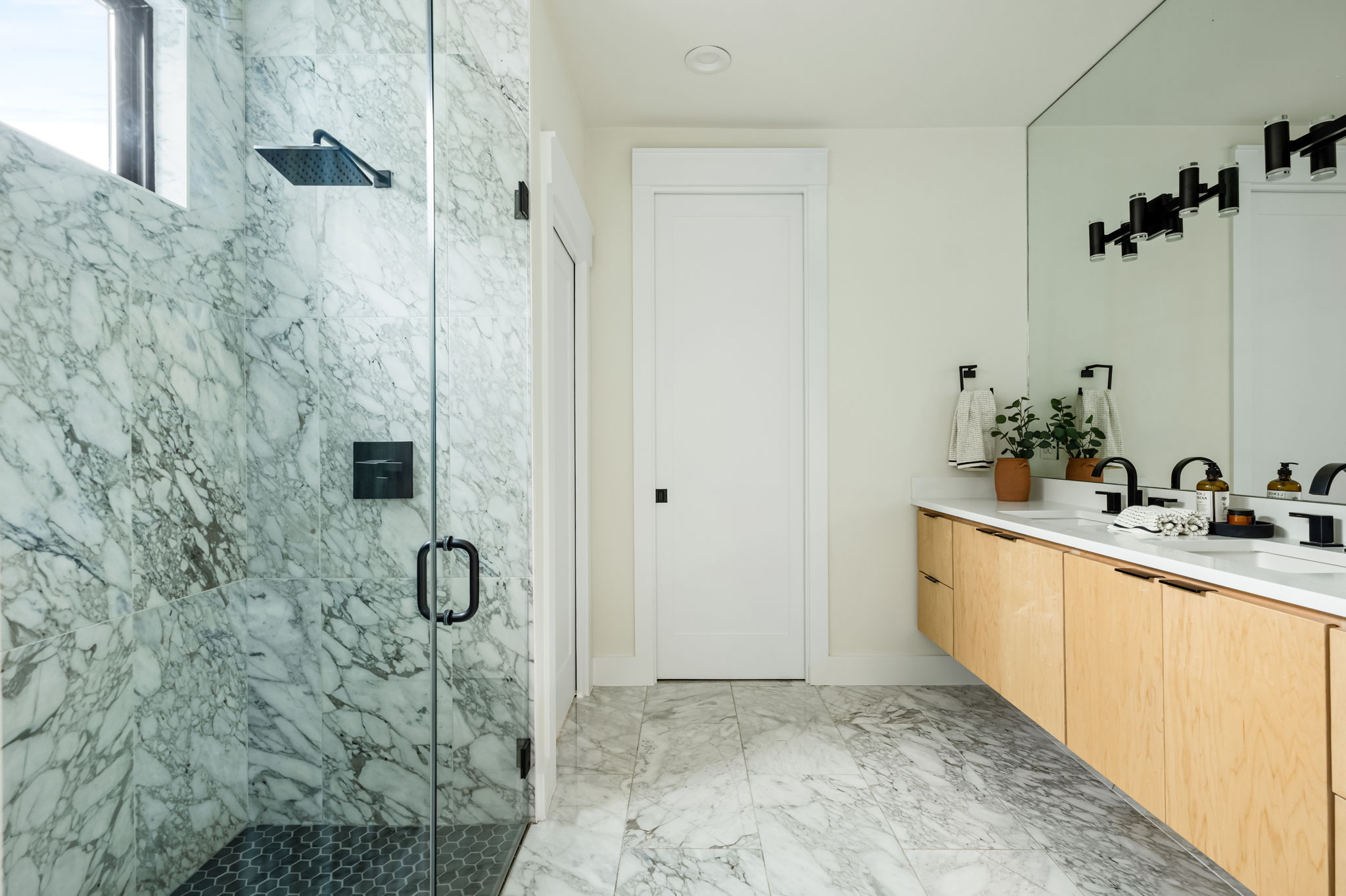 3508 Lyons Road Austin, TX 78702 - Photo 16 of 40 Marble-clad shower and floor define this well-appointed bathroom with a spacious double vanity.