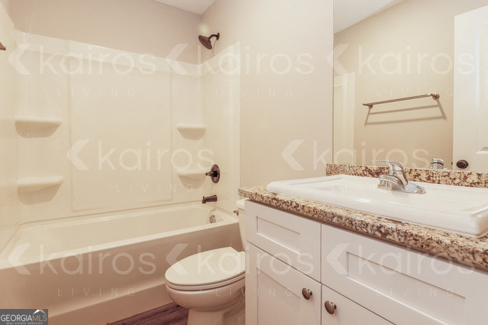 155 Cottage Grove Road Brunswick, GA 31525 - Photo 14 of 16 a bathroom with a granite countertop sink a toilet and shower