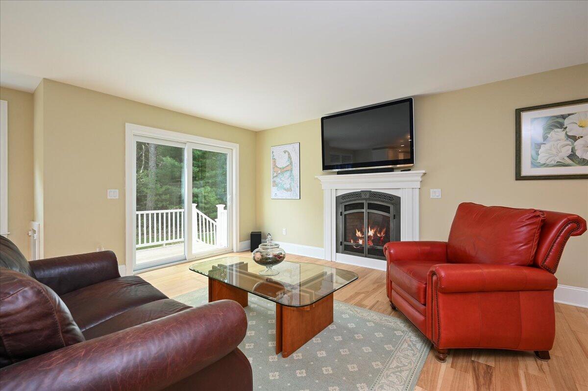 275 Cotuit Road Mashpee, MA 02649 - Photo 9 of 47 a living room with furniture fireplace and flat screen tv