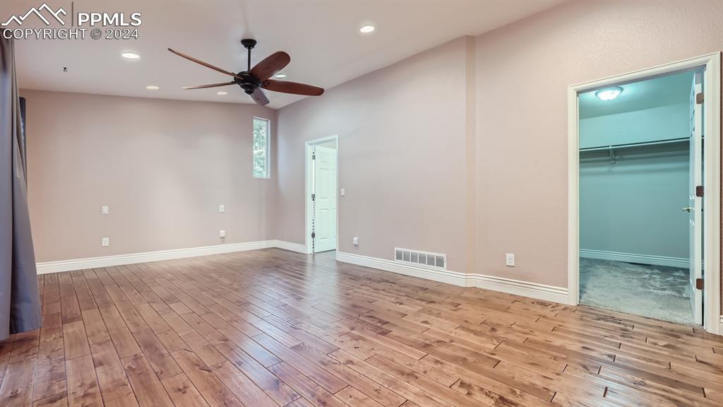 16635 High Tree Drive Elbert, CO 80106 - Photo 15 of 44 an empty room with wooden floor and a ceiling fan