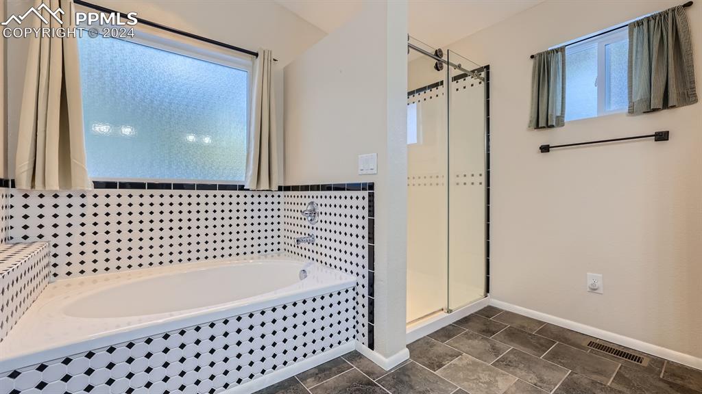 16635 High Tree Drive Elbert, CO 80106 - Photo 16 of 44 a bathroom with a bathtub and shower