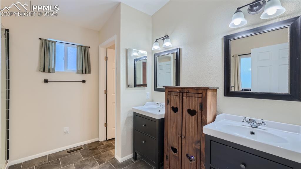 16635 High Tree Drive Elbert, CO 80106 - Photo 17 of 44 a bathroom with a sink vanity and mirror