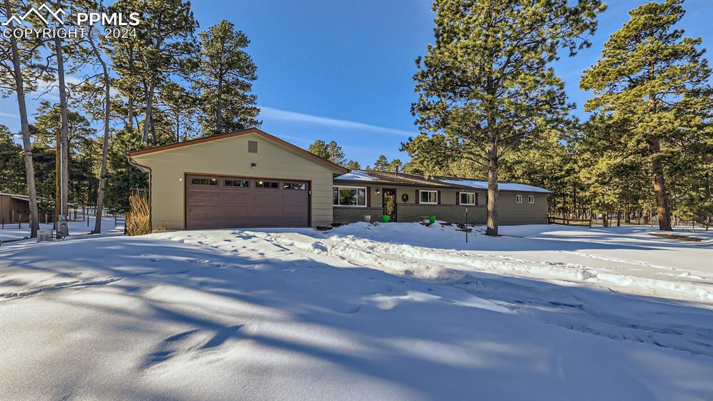 16635 High Tree Drive Elbert, CO 80106 - Photo 2 of 44 a front view of a house with a yard and garage