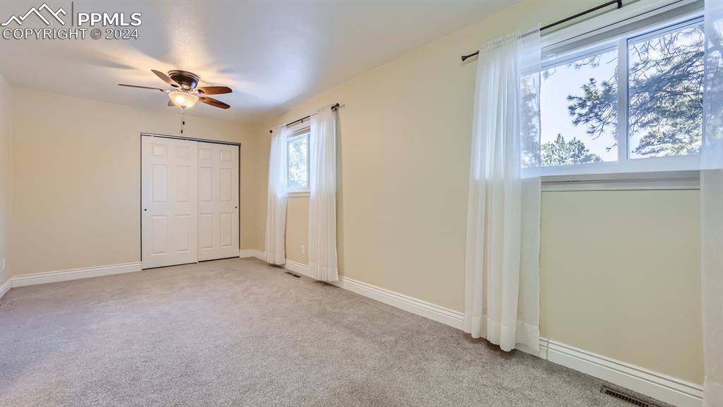 16635 High Tree Drive Elbert, CO 80106 - Photo 22 of 44 an empty room with windows and fan
