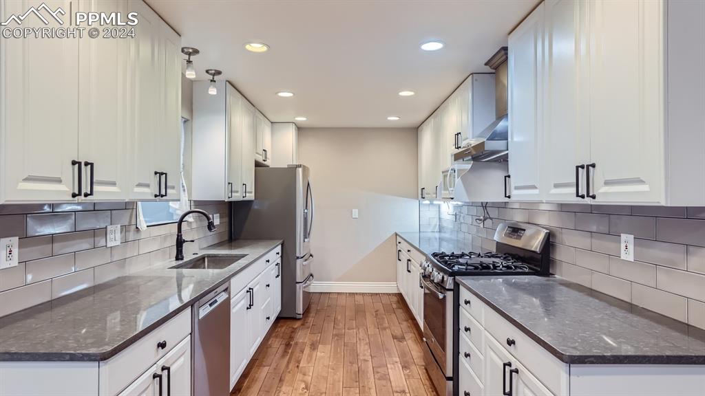 16635 High Tree Drive Elbert, CO 80106 - Photo 6 of 44 a kitchen with stainless steel appliances granite countertop a sink stove and refrigerator