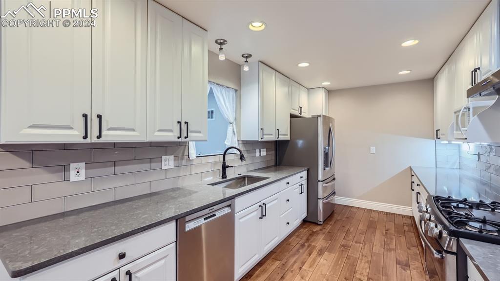 16635 High Tree Drive Elbert, CO 80106 - Photo 7 of 44 a large kitchen with stainless steel appliances a large counter top a stove a sink and a refrigerator