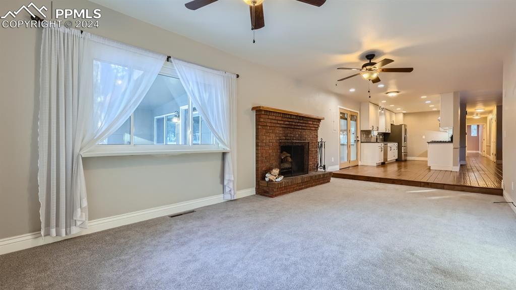 16635 High Tree Drive Elbert, CO 80106 - Photo 10 of 44 an empty room with windows and fireplace