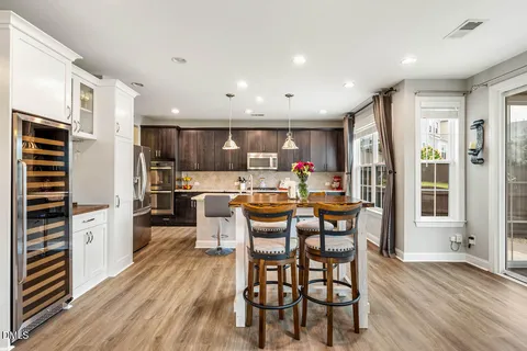 a view of a dining room with furniture and a chandelier