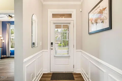a living room with furniture a large window and a flat screen tv