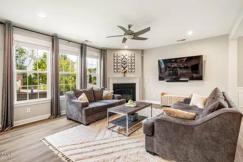a kitchen with stainless steel appliances a dining table chairs and wooden floor