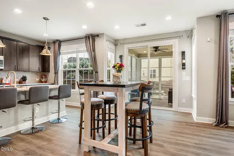 a kitchen with stainless steel appliances kitchen island granite countertop a refrigerator and wooden cabinets