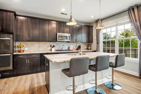 a kitchen with granite countertop stainless steel appliances and wooden cabinets