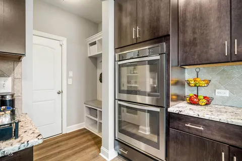 a kitchen with stainless steel appliances granite countertop a sink a stove and cabinets