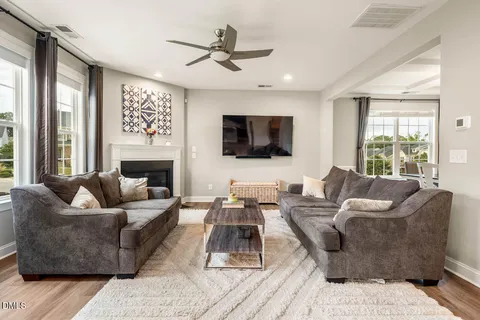 a view of a dining room with furniture and a chandelier