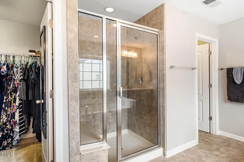 a view of walk in closet with clothes