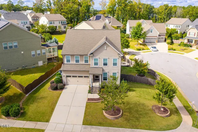 an aerial view of a house with a swimming pool