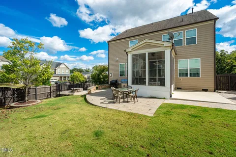 a living room with furniture a large window and a flat screen tv