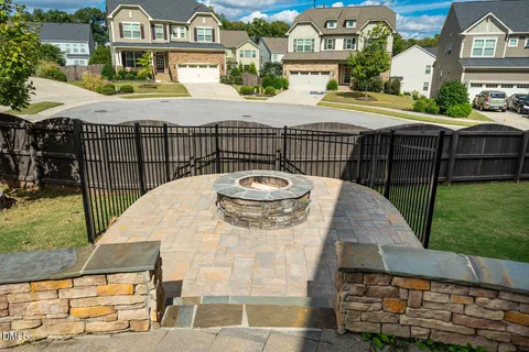 a view of a white house with a yard and furniture