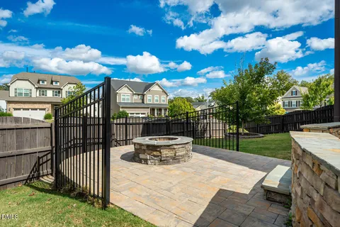 a kitchen with stainless steel appliances a dining table chairs and wooden floor