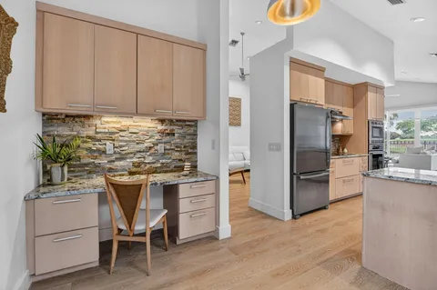 a kitchen with a refrigerator and a sink